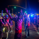 Protesters raise their arms near a line of deputies in riot gear during a march in reaction to the fatal police shooting of an unarmed black man, Alfred Olango, on Sept. 30, 2016, in El Cajon, Calif.
David McNew/Getty Images